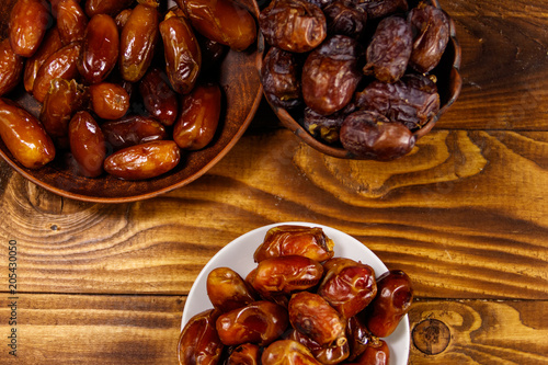 Dried dates fruit on wooden table. Top view