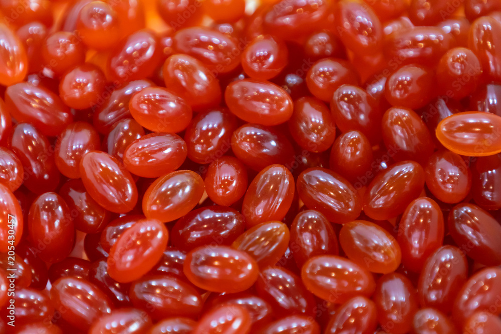Background - close up of countless red colourful medicine pills with shallow depth of field, bokeh Background - close up of countless red colourful medicine pills with shallow depth of field, bokeh