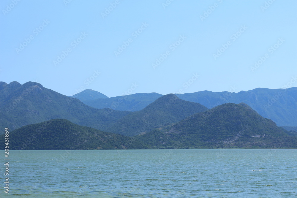 Blue background with calm sea and mountains. montenegro