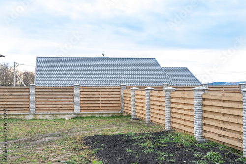 fence of wood with brick poles