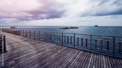 Wooden Beach Dock or Wooden Pier at Tropical Beach © Hermiadi