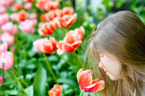 Young happy teenage girl with a tulip