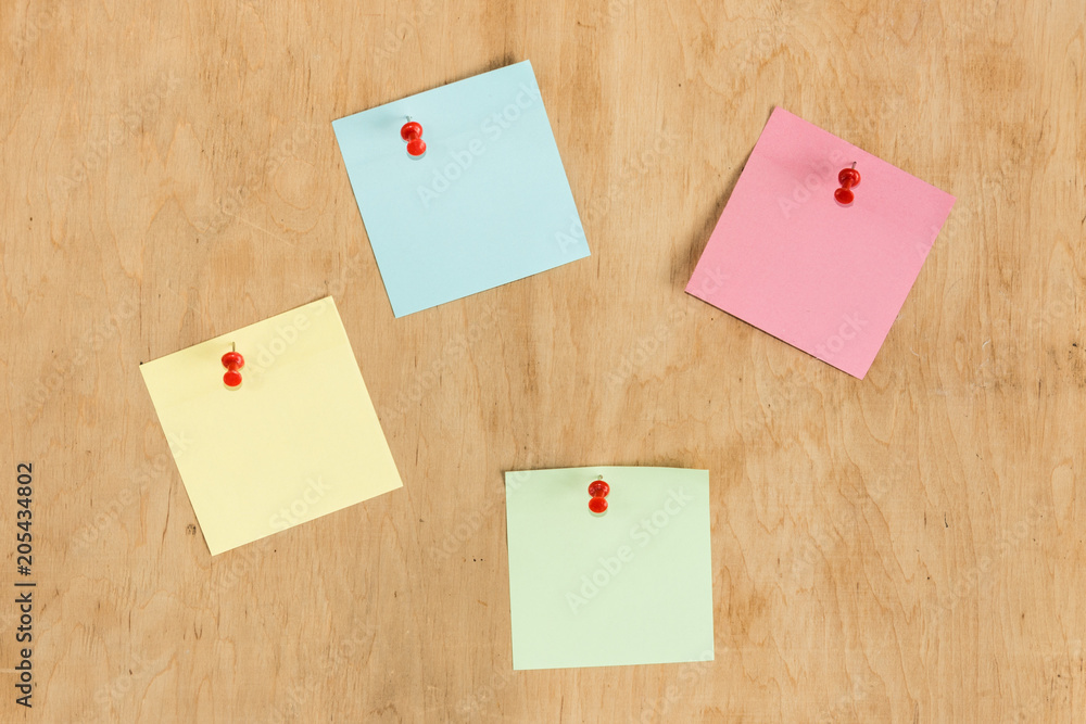 Colorful stickers pin on the wooden board. Colorful stickers pin on the wooden board.