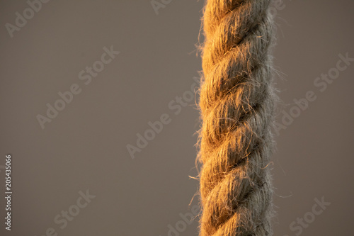 Isolated thick rope on a blurred background. Close-up photo.