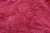 red background of woolen fabric from a piece of clothing