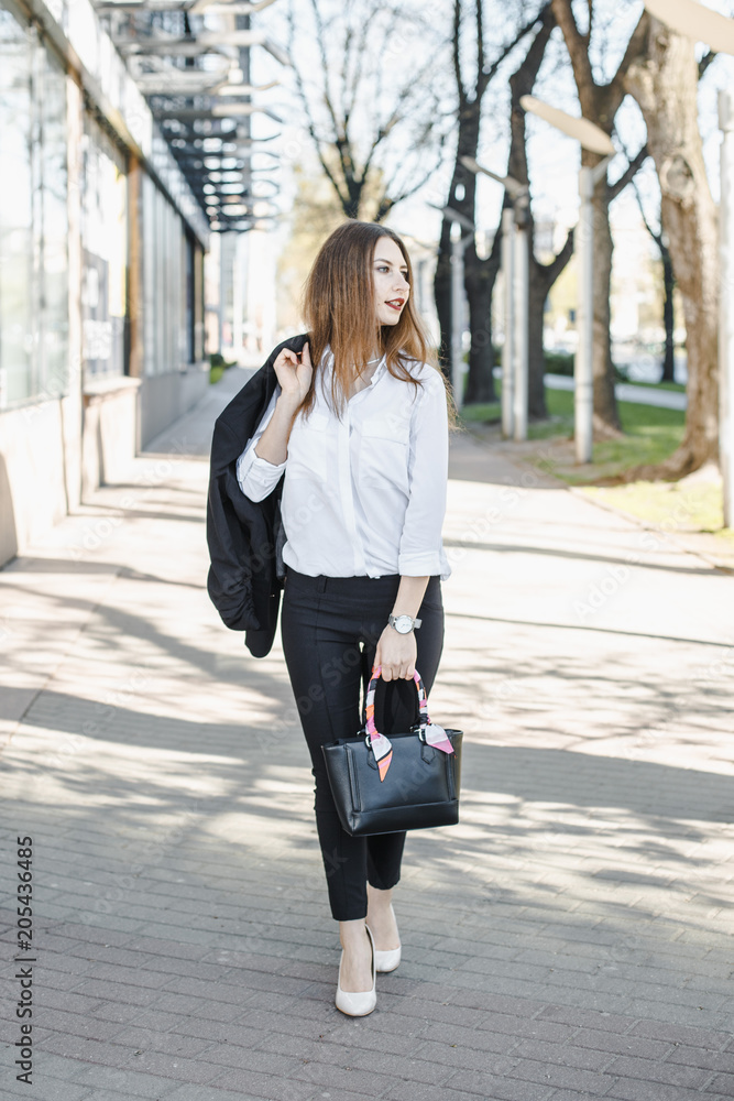 A business woman goes down the street. A girl in a business suit at the office. A wonderful girl in the city. A business woman goes down the street. A girl in a business suit at the office. A wonderful girl in the city.