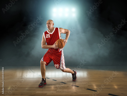 Caucasian Basketball Player in dynamic action with ball 