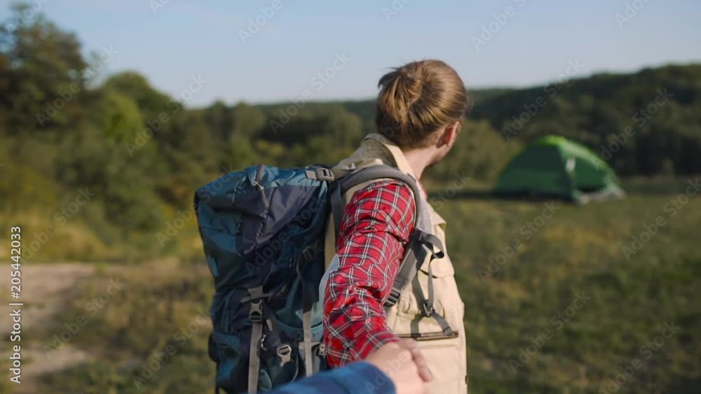 Handsome Tourist Man Traveling In Nature, Holding Woman's Hand. Handsome Tourist Man Traveling In Nature, Holding Woman's Hand.