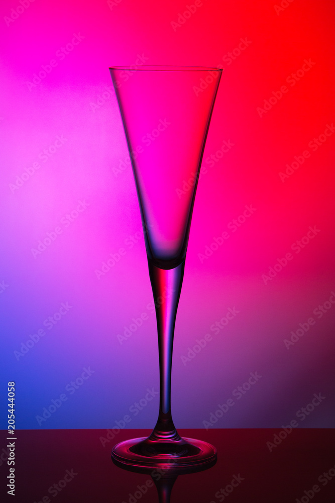 glass of champagne multi-colored background glass of champagne multi-colored background
