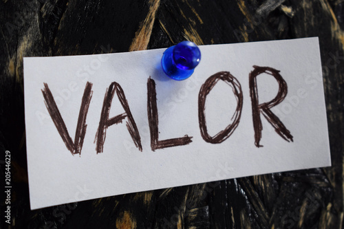 valor written in Spanish, means to courage , on a white sheet of paper.