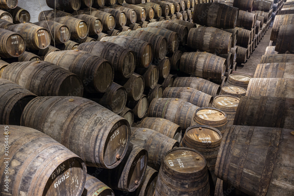 Row of wooden porto wine barrels in wine cellar Porto, Portugal. Row of wooden porto wine barrels in wine cellar Porto, Portugal.