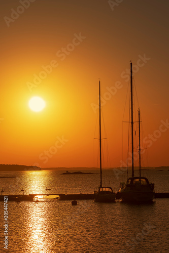 Silhouette of sailboats moo...