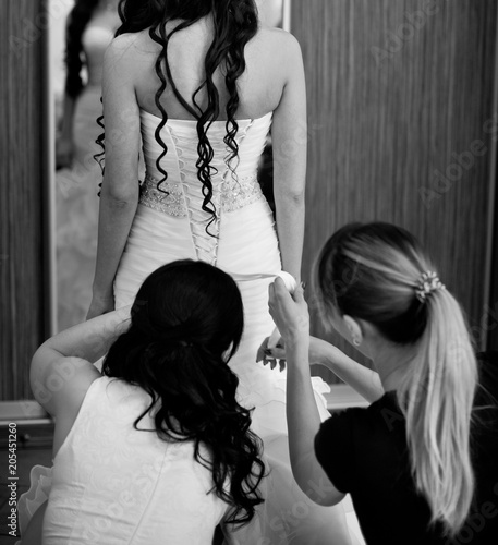 Morning of the bride. Beautiful bride getting dressed and preparing for the wedding