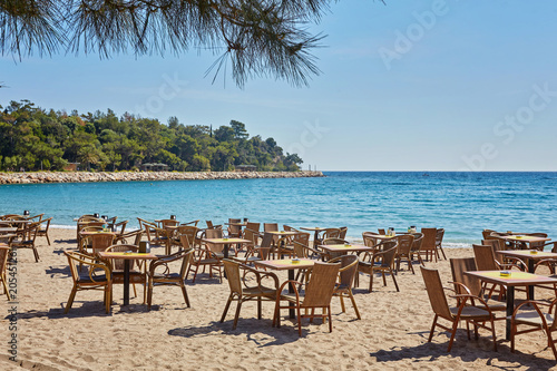 Tables and chairs on terrace in outdoor restaurant with view in Kemer  Turkey.