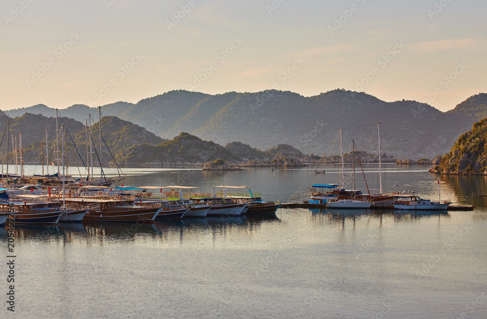 port of Kekova with moored yachts during sunset, Turkey