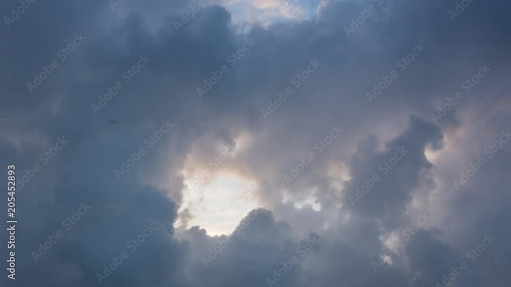 Beautiful cloudscape with large, building clouds and sunrise breaking through cloud mass. Sunrise sky Time lapse Beautiful cloudscape with large, building clouds and sunrise breaking through cloud mass. Sunrise sky Time lapse