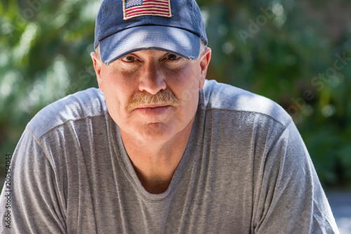 Senior male with serious look wearing USA
