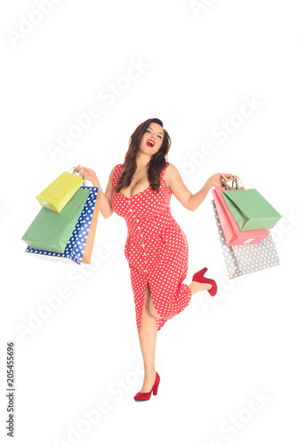 happy plus size woman holding colorful shopping bags isolated on white