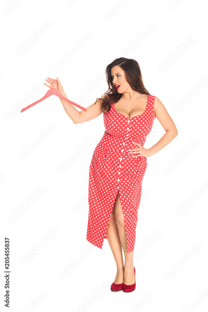 emotional plus size woman with empty hanger in hand isolated on white emotional plus size woman with empty hanger in hand isolated on white