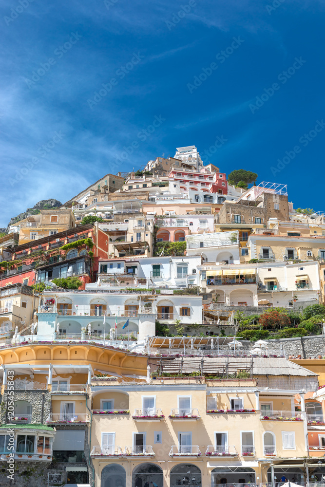 Positano Amalfi Coast Naples Italy - Abstract view of the village colored houses against a blue windy sky.