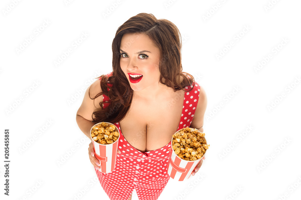 high angle view of smiling plus size woman with buckets of popcorn isolated on white high angle view of smiling plus size woman with buckets of popcorn isolated on white