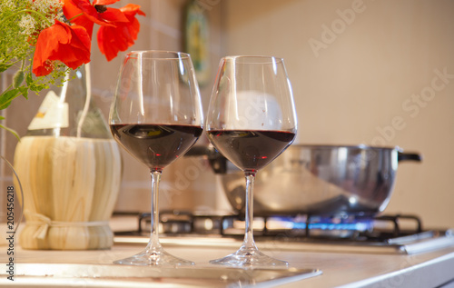 two glasses of red wine on  kitchen table