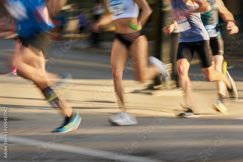 Runners in an Urban Running Race. Competitors in a running race. Motion blur.     © maxdigi