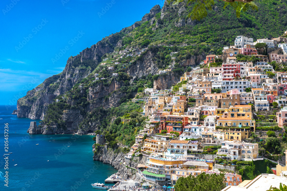 Positano Italy Amalfi Coast Naples - Panoramic view of coloured houses grasping the mountain side and the turquoise Mediterranean sea.