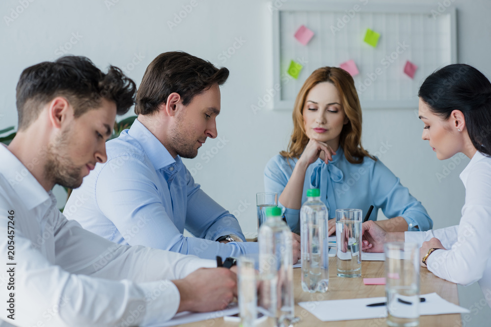 selective focus of focused business people at workplace in office selective focus of focused business people at workplace in office