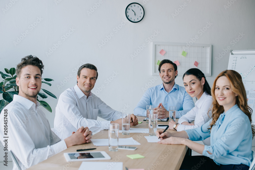 portrait of smiling business colleagues at workplace in office