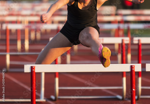 High school girls racing the 100 hurdles