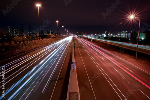 Night photography of HWY 403 in Mississauga, Ontario, Canada from Confederation bridge with detail of high occupancy vehicle sign