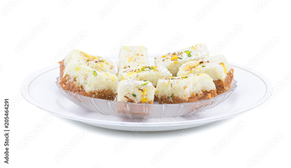 Indian Diwali Sweet Food Kalakand Also Know as Halwa or Mawa Kalakand is a Creamy Delicacy Made From Paneer or Cottage Cheese, The Dish Originated in Alwar, Rajasthan. Isolated on White Background Indian Diwali Sweet Food Kalakand Also Know as Halwa or Mawa Kalakand is a Creamy Delicacy Made From Paneer or Cottage Cheese, The Dish Originated in Alwar, Rajasthan. Isolated on White Background