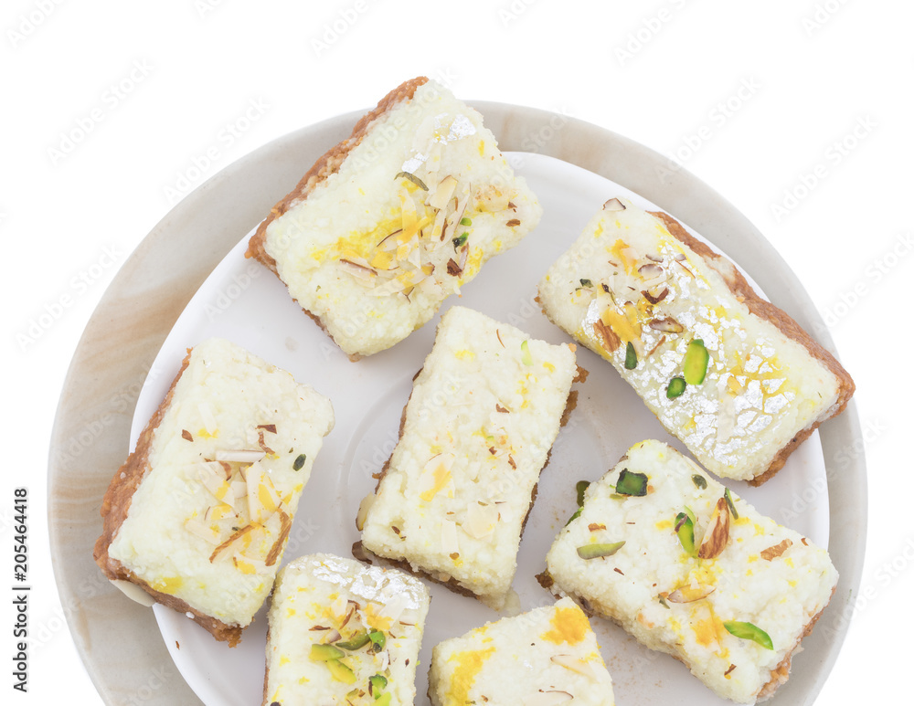 Indian Diwali Sweet Food Kalakand Also Know as Halwa or Mawa Kalakand is a Creamy Delicacy Made From Paneer or Cottage Cheese, The Dish Originated in Alwar, Rajasthan. Isolated on White Background Indian Diwali Sweet Food Kalakand Also Know as Halwa or Mawa Kalakand is a Creamy Delicacy Made From Paneer or Cottage Cheese, The Dish Originated in Alwar, Rajasthan. Isolated on White Background