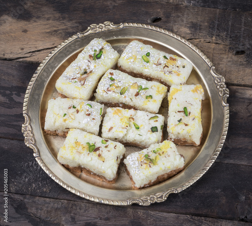 Indian Diwali Sweet Food Kalakand Also Know as Halwa or Mawa Kalakand is a Creamy Delicacy Made From Paneer or Cottage Cheese, The Dish Originated in Alwar, Rajasthan. Kalakand on Wooden Background