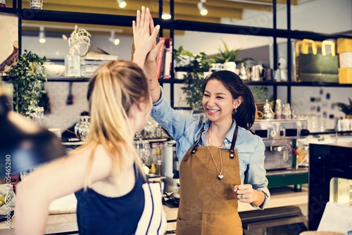 Women give a high five to each other