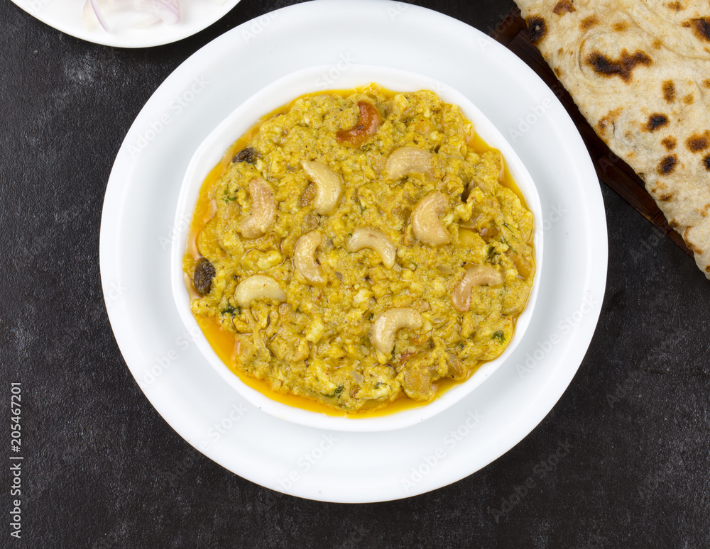 Indian Traditional Vegetarian Cuisine Kaju Curry Also Called Kaju Butter Masala Served with Tandoori Roti, Raita, Salad And Papad Indian Traditional Vegetarian Cuisine Kaju Curry Also Called Kaju Butter Masala Served with Tandoori Roti, Raita, Salad And Papad