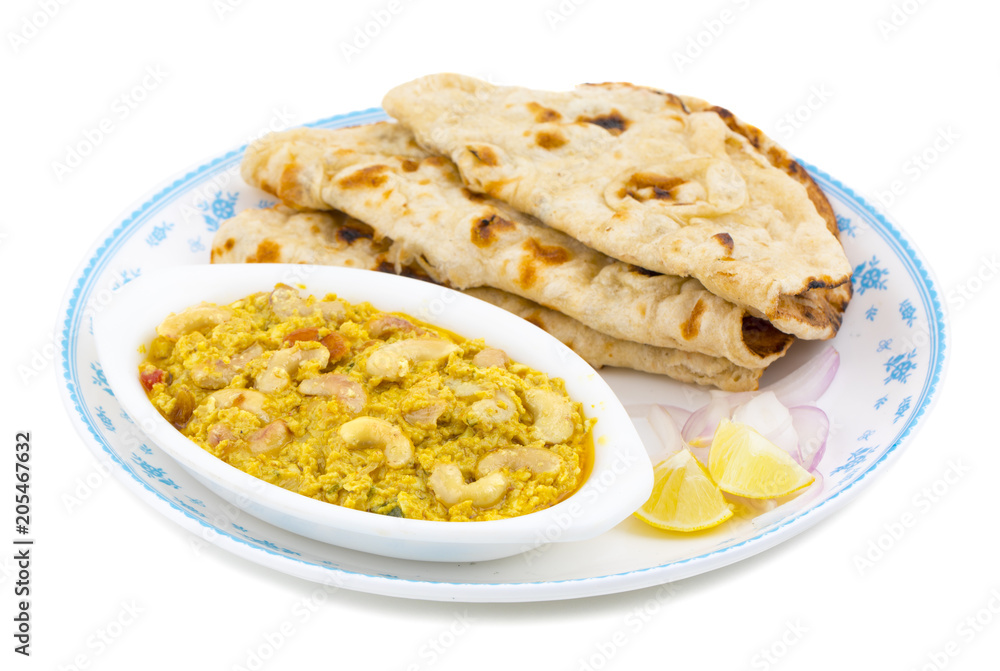 Indian Traditional Vegetarian Cuisine Kaju Curry Also Called Kaju Butter Masala Served With Tandoori Roti And Salad isolated on White Background
