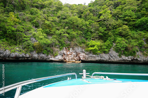 speed boat and green rock mountain