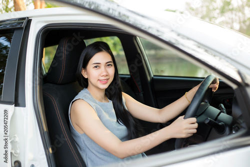 Pretty female driver in a white car