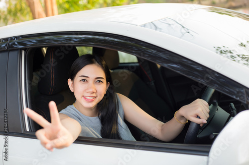 Wallpaper Mural Cute young lady happy driving car Torontodigital.ca