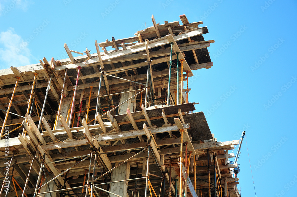 wooden sheeting and metal scaffolds at a construction site