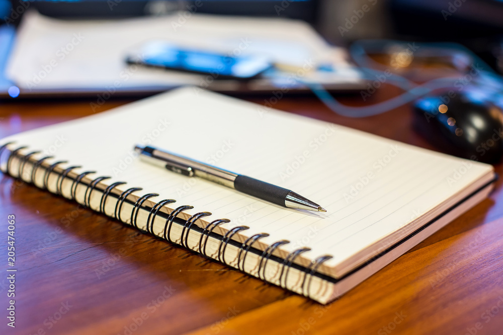 notebook and pen on a wooden table notebook and pen on a wooden table