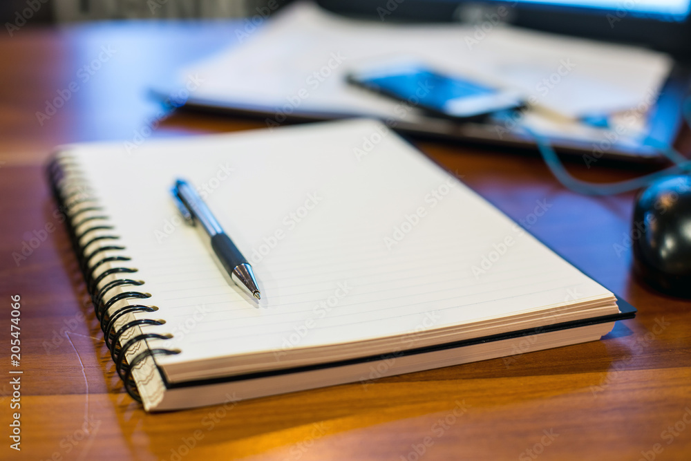notebook and pen on a wooden table notebook and pen on a wooden table