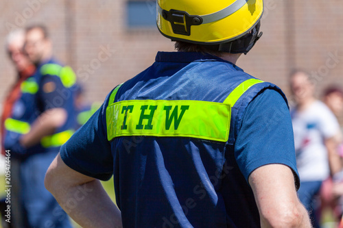 German technical emergency service sign on a vest from a man. THW, Technisches Hilfswerk means technical emergency service. photo