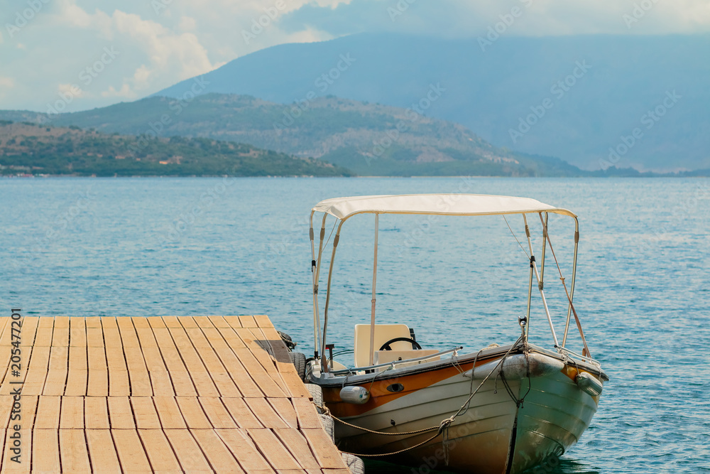 Motor boats drifting in the deep blue sea coast at pier.Sea background.Crystal clear water,good sunny weather.Beautiful blue lagoon for summer vacation trip