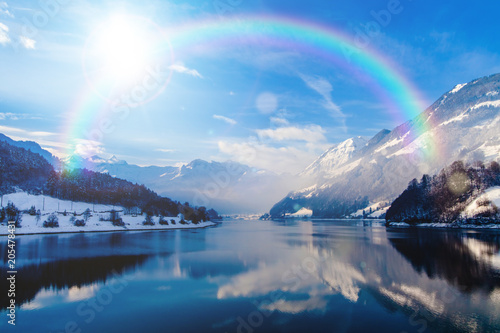 beautiful landscape in winter with rainbow