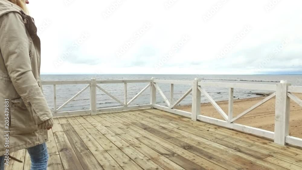 beautiful girl on a pier in cloudy weather beautiful girl on a pier in cloudy weather