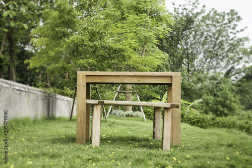 Wooden bench in outdoors garden in summer