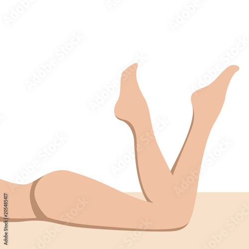 Sexy female legs on the beach flat